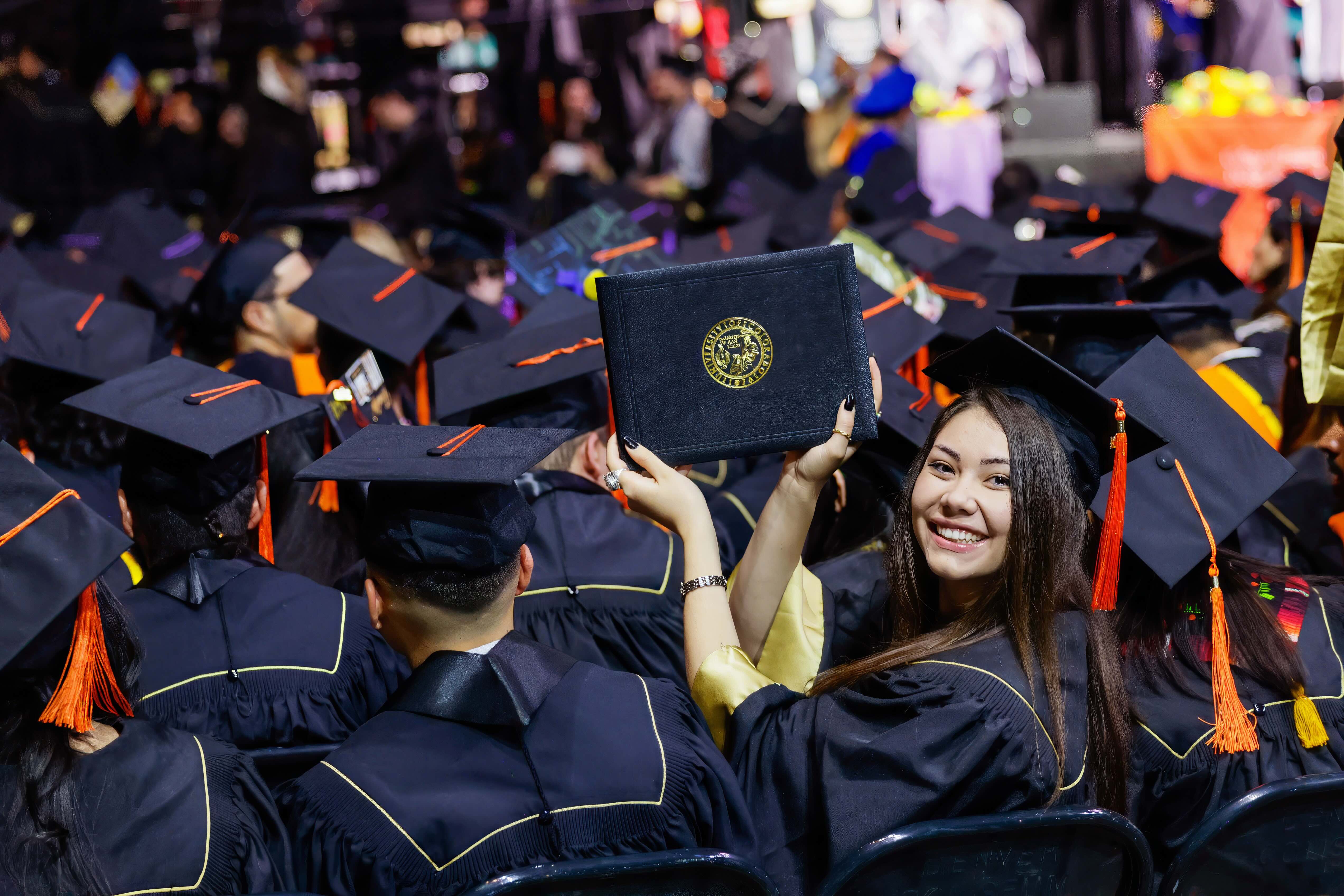 CEDC Grad holds up degree