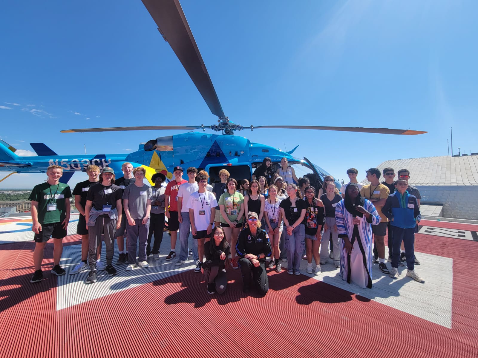 BOLT camp participants in front of helicopter