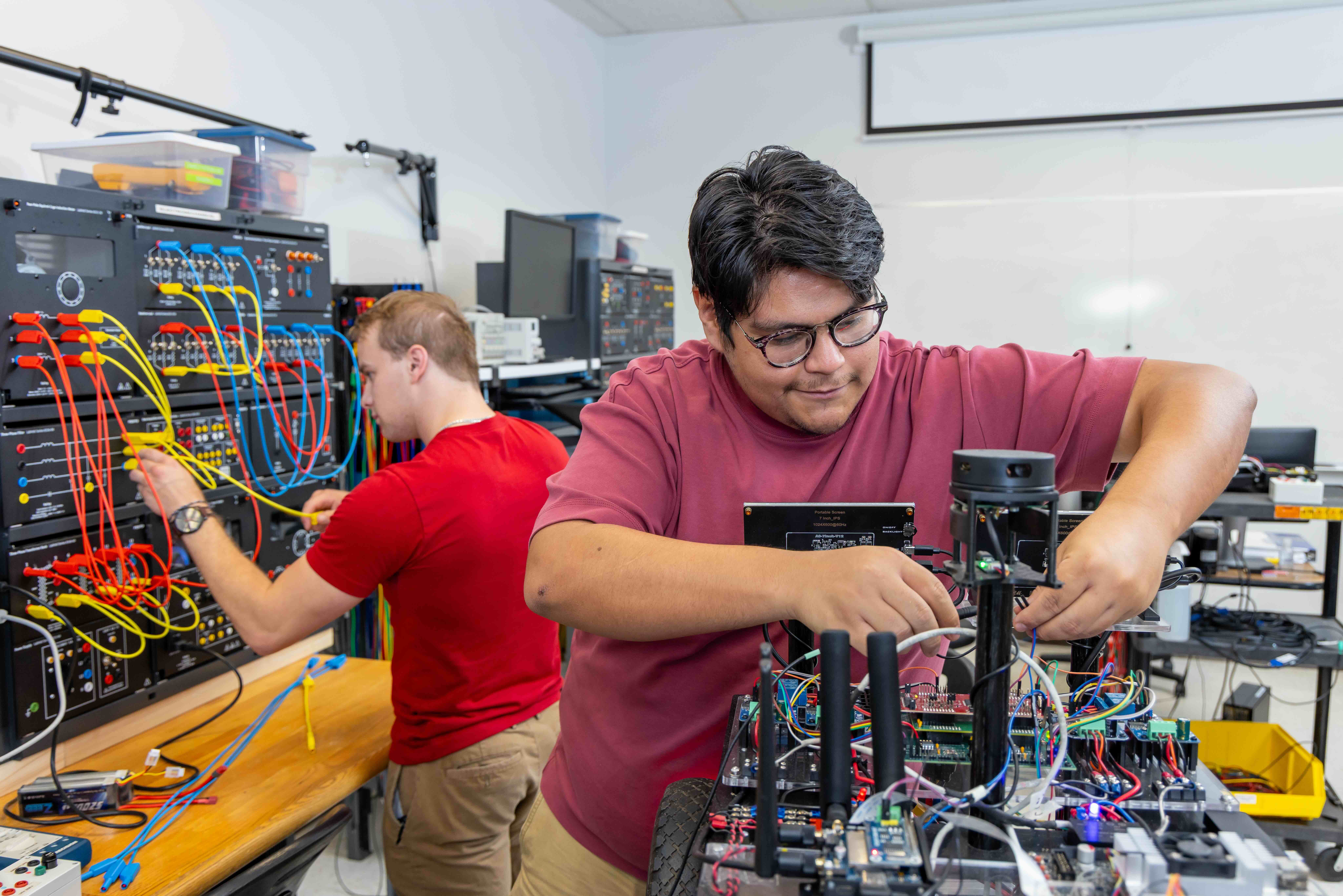 two Electrical Engineering students working in the lab