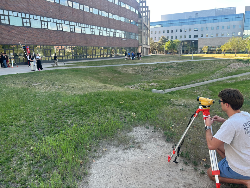 Students complete a level-loop exercise, connecting instrument setup and field observations with elevation calculations and closure checks.