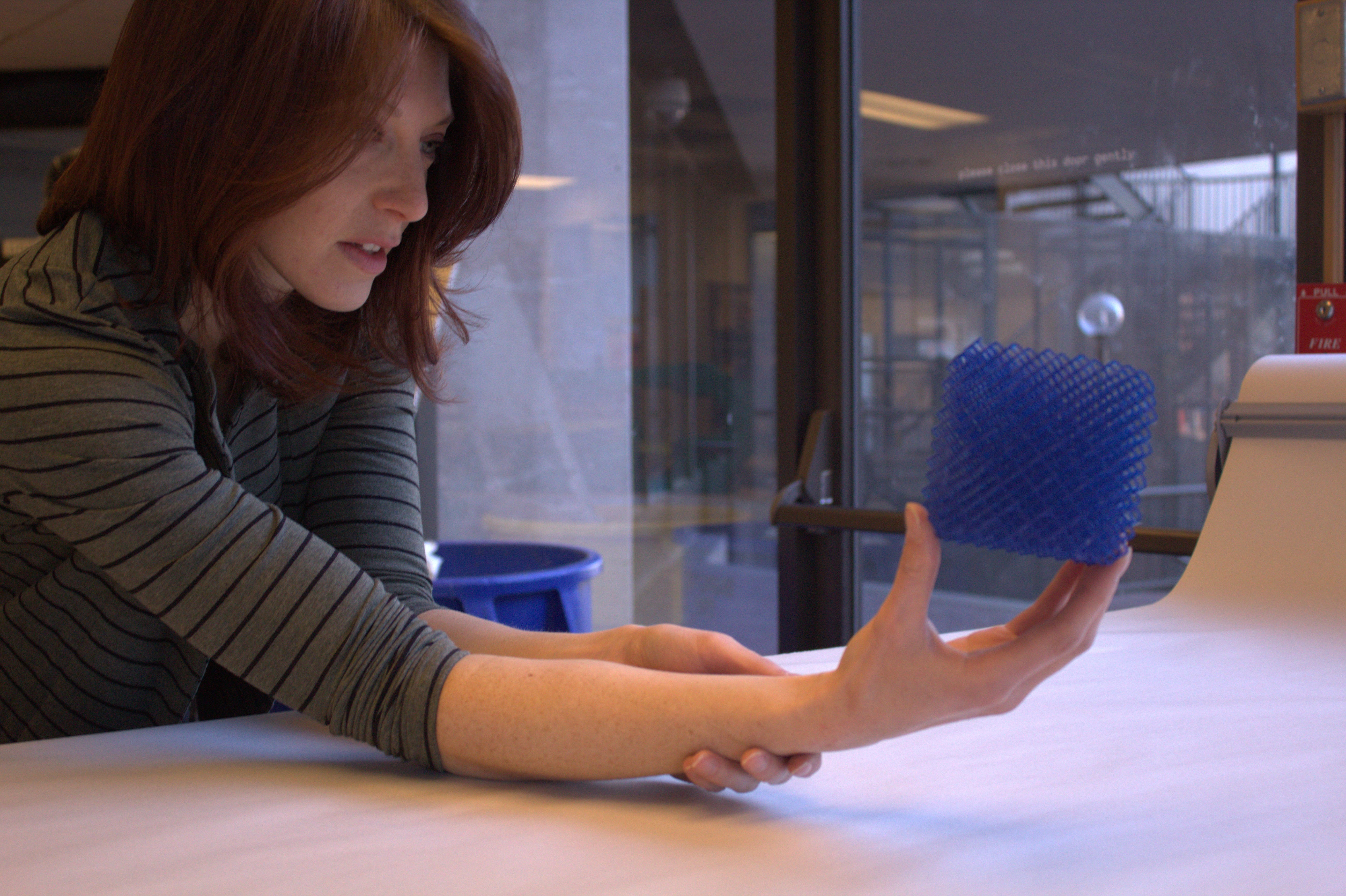 Woman holding 3D-printed object